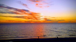 Enjoy a serene sunset over the calm sea with breathtaking views of the horizon.