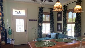 A kitchen with a wooden countertop, a sink, and a window with curtains. - Stylish 2 BED, 2 BATH Shotgun-style house near beach! (Galveston)