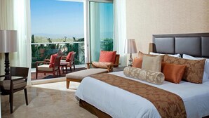 A hotel room with a large bed, a balcony with chairs, and a view of the outdoors. - Vidanta, 5 Diamond Resort 1Br 1 1/2 Ba + golf 2 for 1 massages (Nuevo Vallarta)