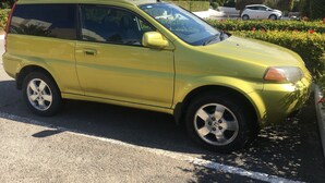 A yellow minivan parked on a street with a white line marking. - Apartment in Kato Paphos (Phafos)