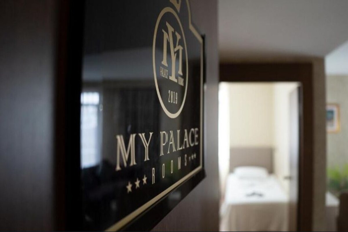 A hotel sign with the text "MY PALACE 2019" and "ROOMS".