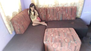 A sectional sofa with a patterned cover and a matching ottoman. - San Fernando Pampanga (Sanfernando)