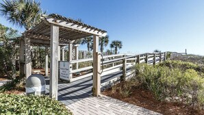 A wooden boardwalk leading to a gazebo with a sign indicating handicap ramp access at The Ramada Inn. - Welcome to Relaxation! Gulfside Villa 408 (Fort Walton Beach)