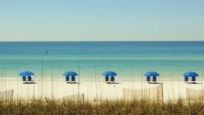 A beach with five blue umbrellas and lounge chairs. - Welcome to Relaxation! Gulfside Villa 408 (Fort Walton Beach)