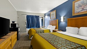 A hotel room with two beds, a television, a desk, and a painting on the wall. - Knights Inn Collinsville Va (Collinsville)