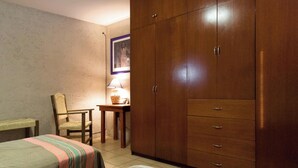 A bedroom with two beds, a wooden wardrobe, a chair, a table with a lamp, and a framed picture on the wall. - La Casita del Abuelo, beautiful Oaxaca typical house  (San Felipe del Agua)
