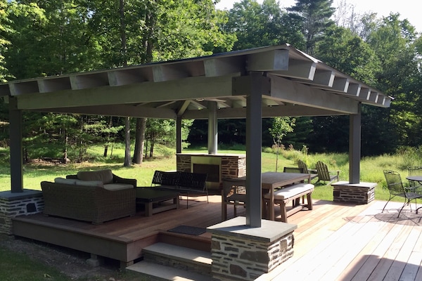 Weather-resistant outdoor room, with fireplace, ceiling fan and lighting