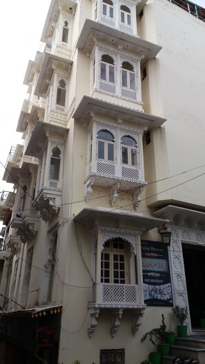 A multi-story building with ornate balconies and windows.