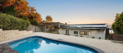 Ellerina solar-heated pool, complete with elegant landscaping and ample seating