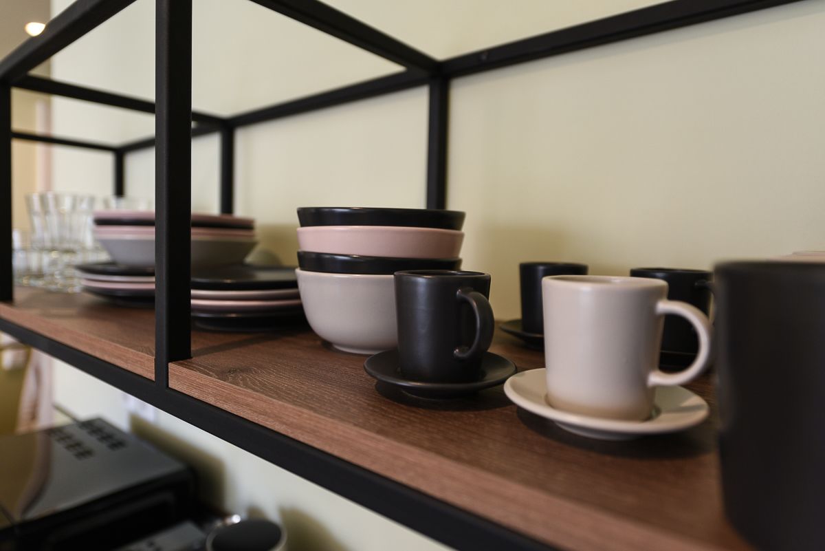A shelf with stacked bowls and cups.