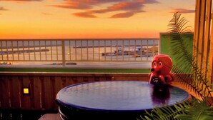 A view from a balcony with a railing, a pool, and a toy octopus. - Himakajima Ocean View Hotel Seikaiso (Minamichita)