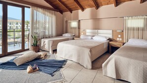 A hotel room with two beds, a large window, and a balcony.
