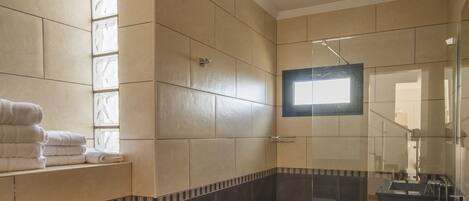 A bathroom with a bidet, a sink, and a mirror.