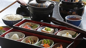 A traditional Japanese meal setup with various dishes and a tea pot. - Koujin no Yado Sanpou (Kami)