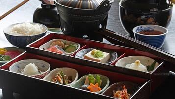 A traditional Japanese meal setup with various dishes and a tea pot.