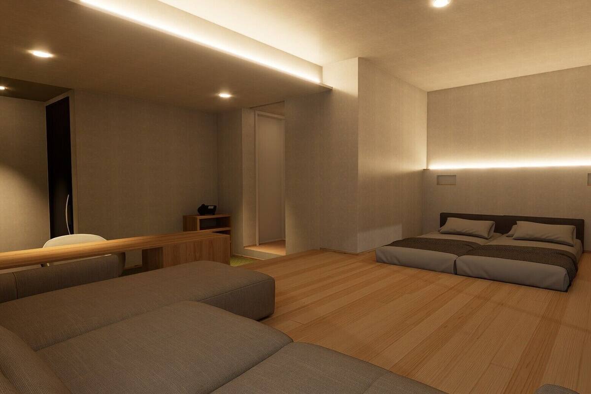 A modern bedroom with a bed, a sofa, and a small wooden table.