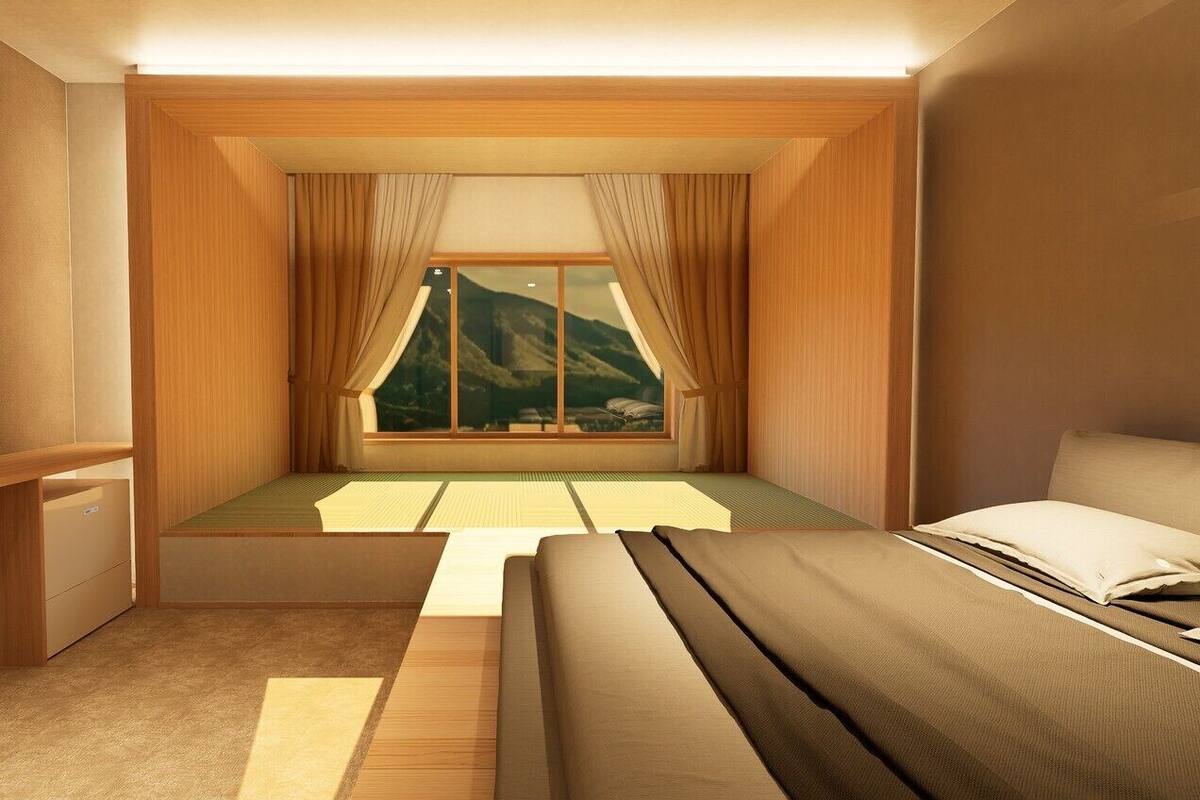 A room with a bed, a window with curtains, a wooden desk, and a view of mountains.