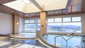 A modern indoor pool area with large windows and a view of the outside. - Aso Kumamoto Airport Hotel Eminence (Mashiki)