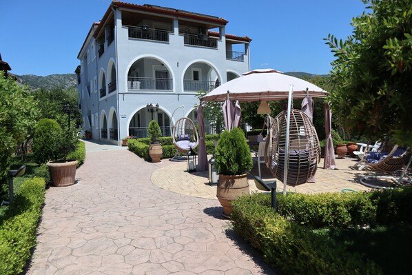 Enjoy a tranquil retreat with a balcony and outdoor seating area surrounded by lush greenery.