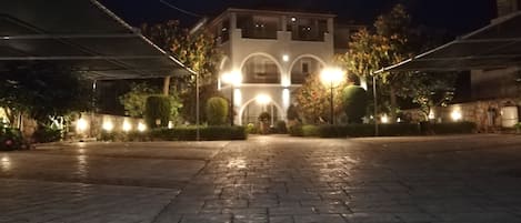 A paved courtyard with a building in the background.