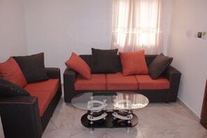 Standard Apartment | Living room | 40-inch LCD TV with cable channels, TV - Elu Hotel Appart (Douala)