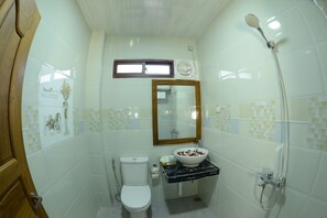 A bathroom with a toilet, sink, and shower. - Bagan Comfort Hotel (Nyaung-U)