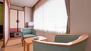 A room with a sofa, a small table, a television, and a wardrobe. - Yuda Onsen Bochoen (Yamaguchi)