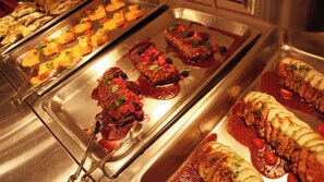 A buffet with various dishes including meat, vegetables, and sauces. - Yuda Onsen Bochoen (Yamaguchi)