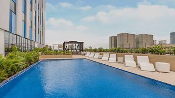 Outdoor pool, open 7:00 AM to 10:00 PM, pool loungers
