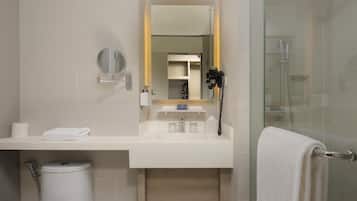 A modern bathroom with a toilet, sink, and shower.