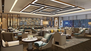A modern hotel lobby with a bar area, seating arrangements, and a city view. - Radisson Hangzhou Qianjiang (Hangzhou)