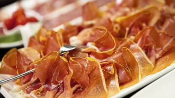 A plate of thinly sliced cured meat arranged in a fan shape.