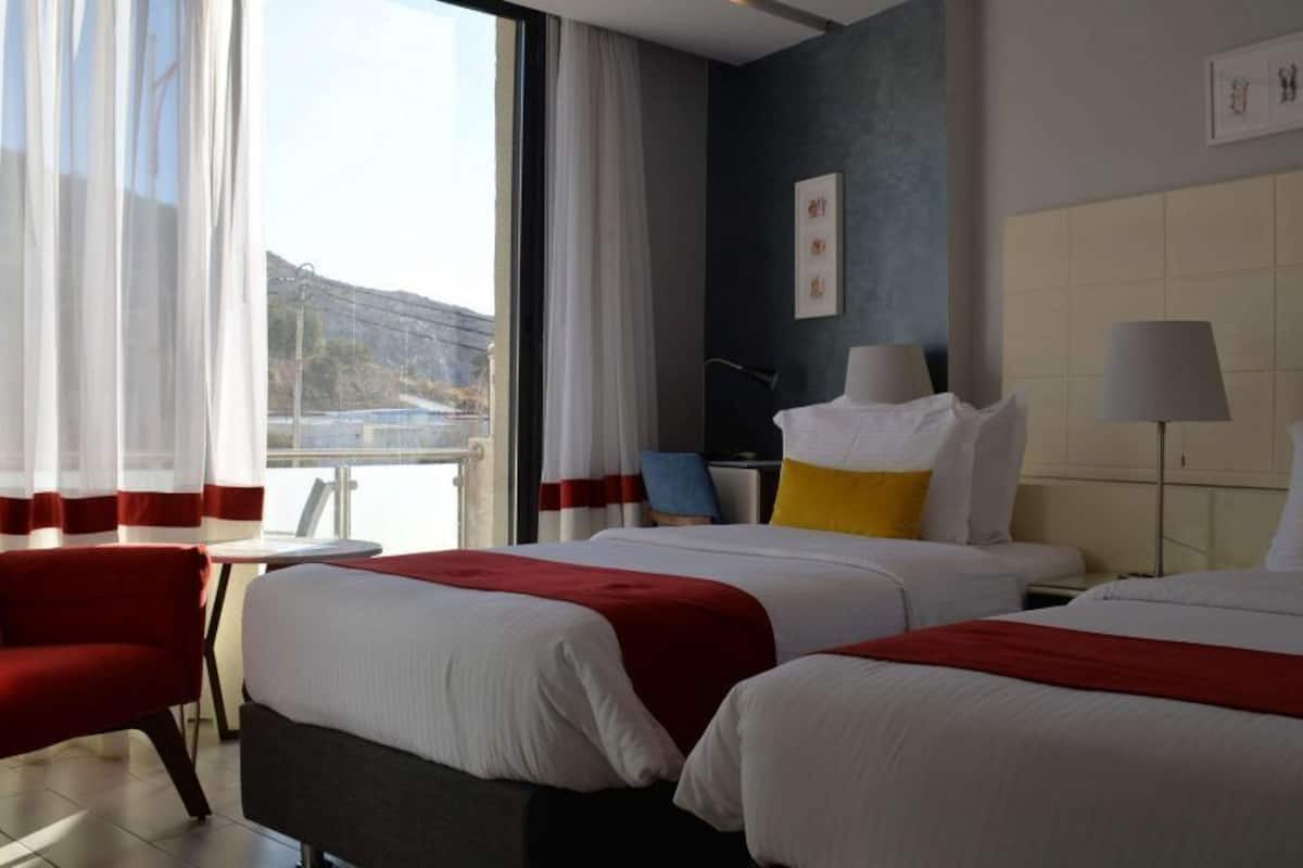 deluxe room, 2 single beds, city view | free minibar items, in-room safe, desk, blackout curtains