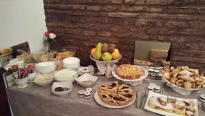 A buffet table with various food items, including fruits, pastries, and desserts. - Domus Del Corso Spagna (Rome)