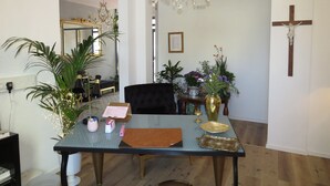 A dining area with a chandelier, a cross on the wall, and potted plants. - Boutique-Hotel 'Altes Rathaus' (Lahnstein)