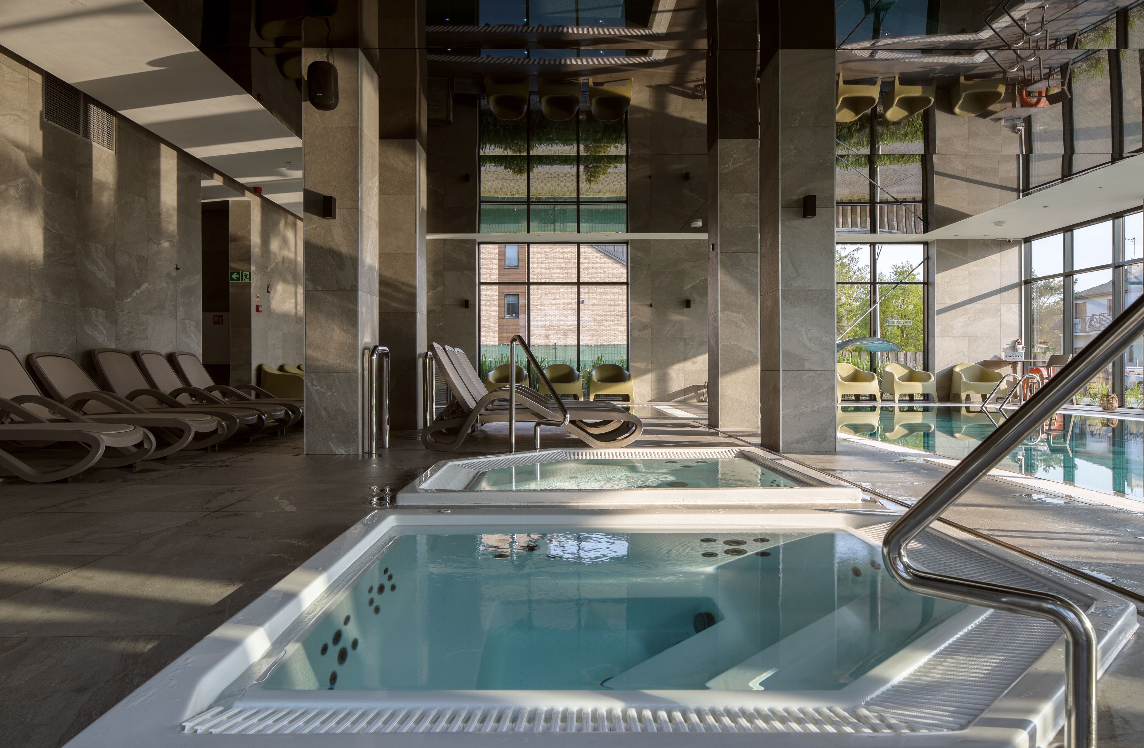 indoor pool, seasonal outdoor pool, pool loungers, lifeguards on site