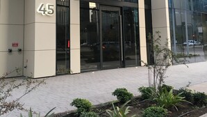 A modern building with a glass facade and a sign for "ONE Apartments." - One Nk Apartments (Santiago)