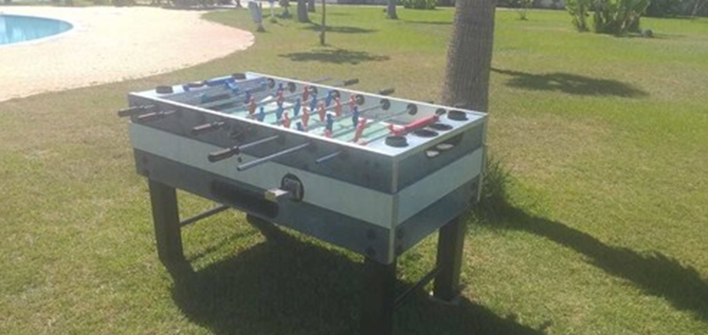 A foosball table in an outdoor setting.