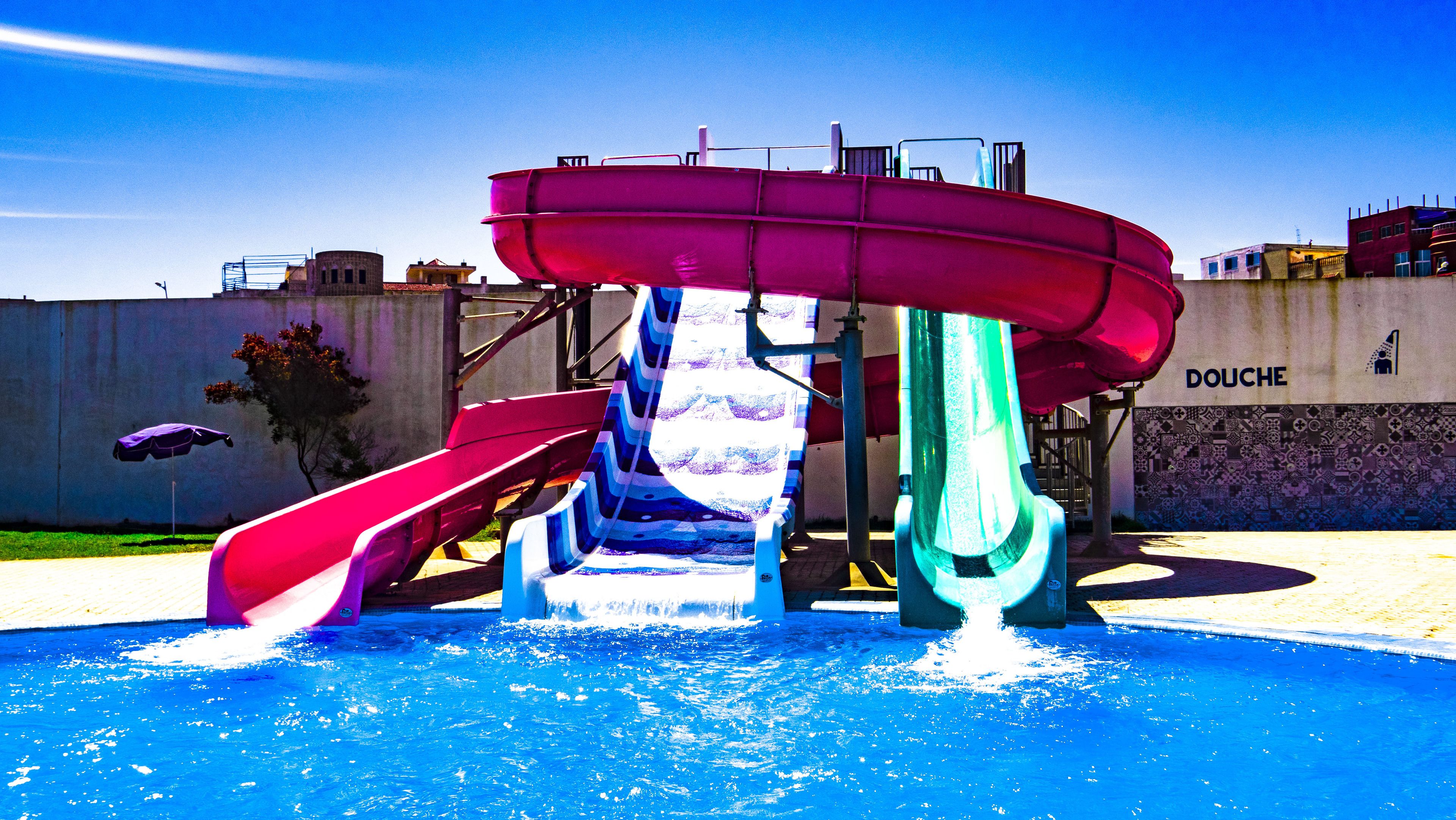 A water park with multiple slides and a pool.