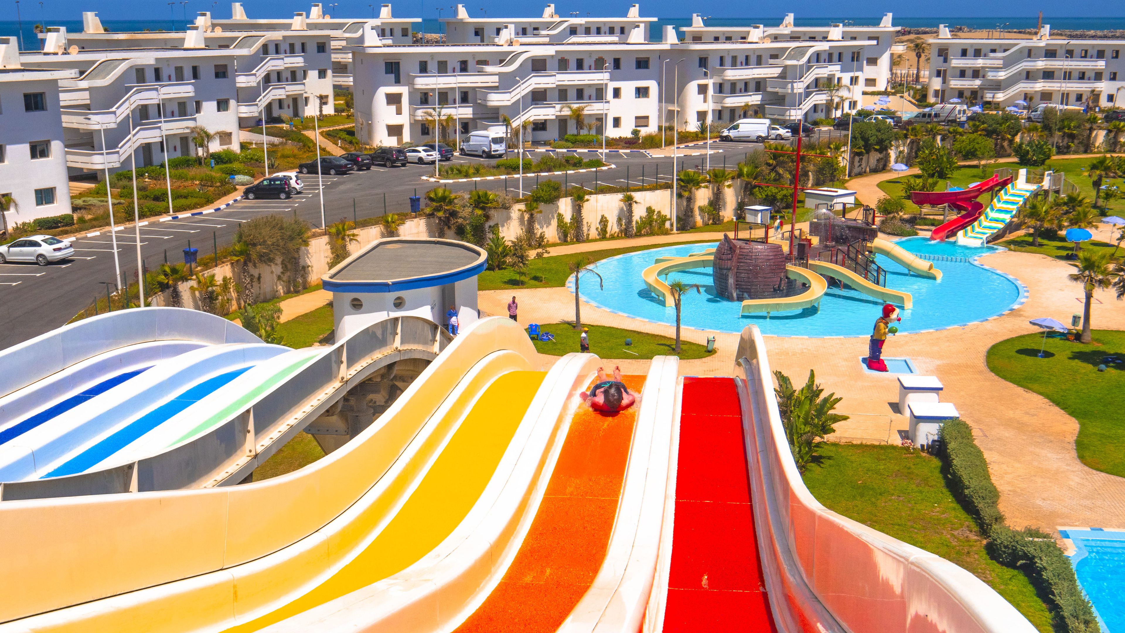 A water park with multiple slides and a pool area.