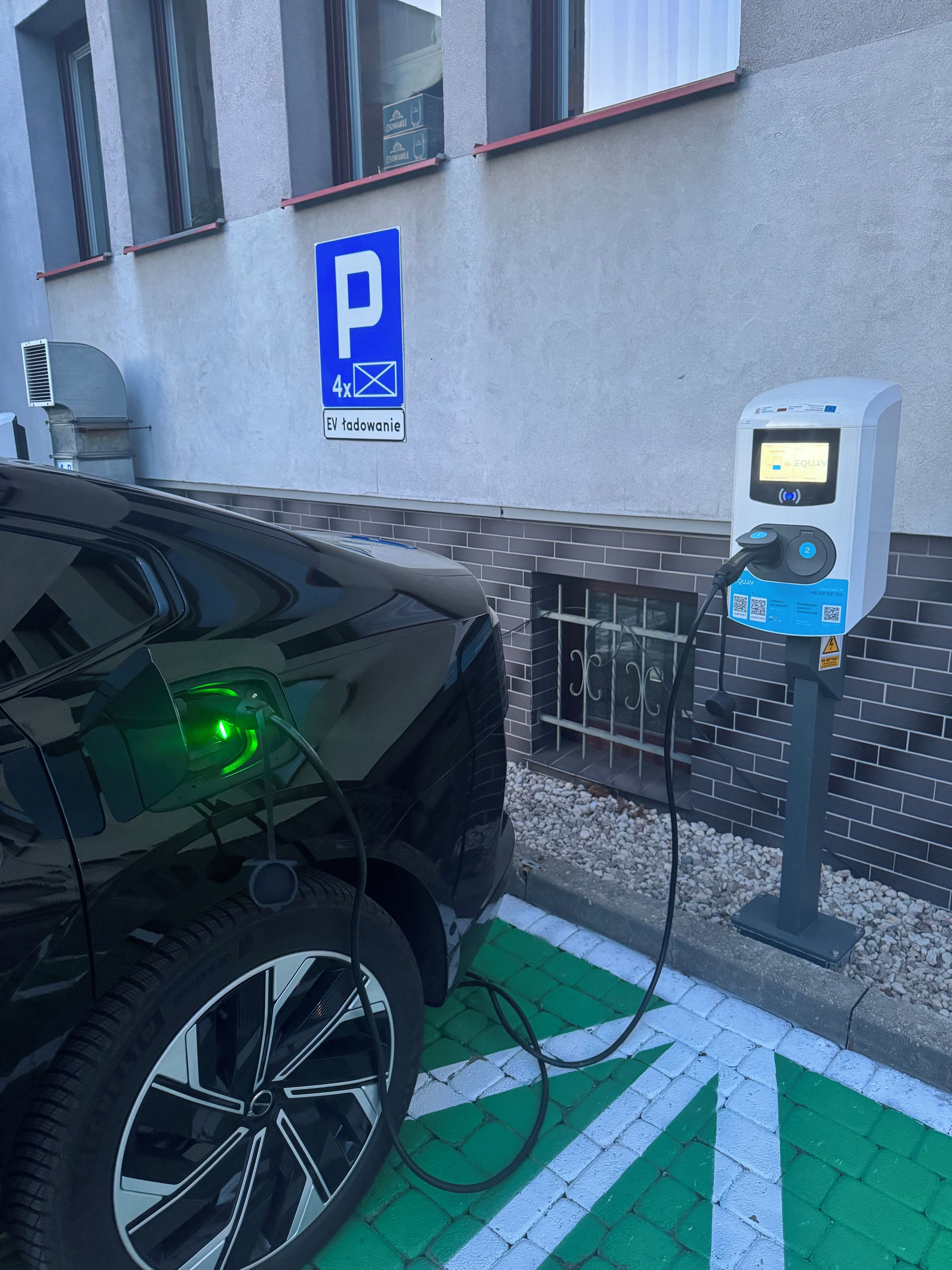A parking space with a charging station for an electric vehicle.
