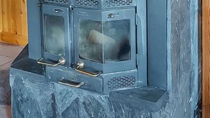 A stone fireplace with a wooden interior and a stone exterior. - Harjurinne by Interhome (Lestijärvi)