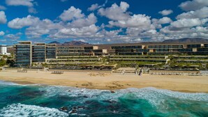 A coastal hotel with multiple buildings, a sandy beach, and ocean waves. - The Residences at Solaz, a Luxury Collection Resort, Los Cabos a Marriott Hotel (San José del Cabo)