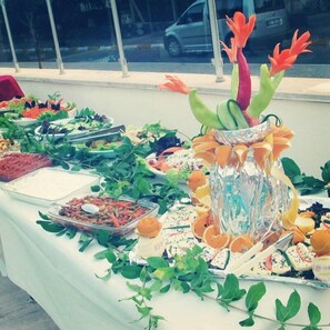 A buffet table with various food items and a decorative centerpiece. - Icmeler Prestij Apart (Marmaris)