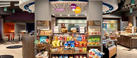 A 24/7 market kiosk with snacks, beverages, and a coffee station.