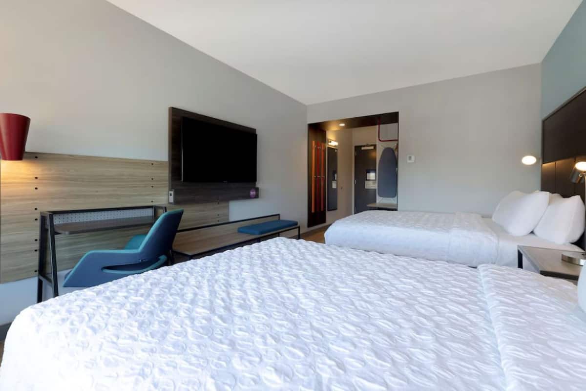 Premium bedding, desk, laptop workspace, blackout drapes