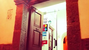 A doorway with a sign indicating acceptance of VISA, MasterCard, and AMERICAN EXPRESS. - International Hostels (Cusco)