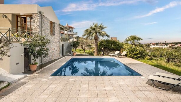 A modern pool area with a clear view of the surrounding buildings and greenery. - Villa 15  Elegant Private Pool Family (Rethymno)