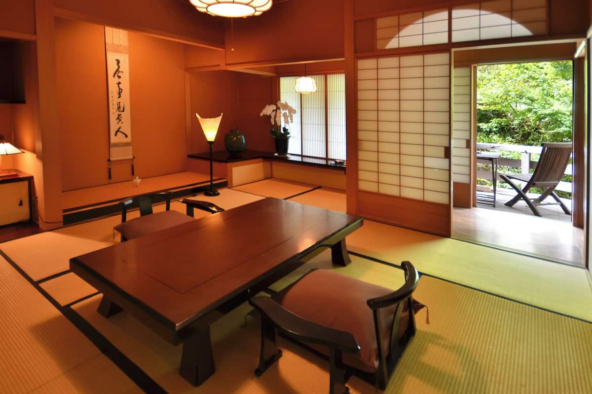 Ein traditioneller japanischer Raum mit Tatami-Böden, einem niedrigen Tisch und Shoji-Schirmen.