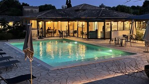 A poolside area with a swimming pool, outdoor seating, and a covered patio. - Prea Gianca (Bonifacio)